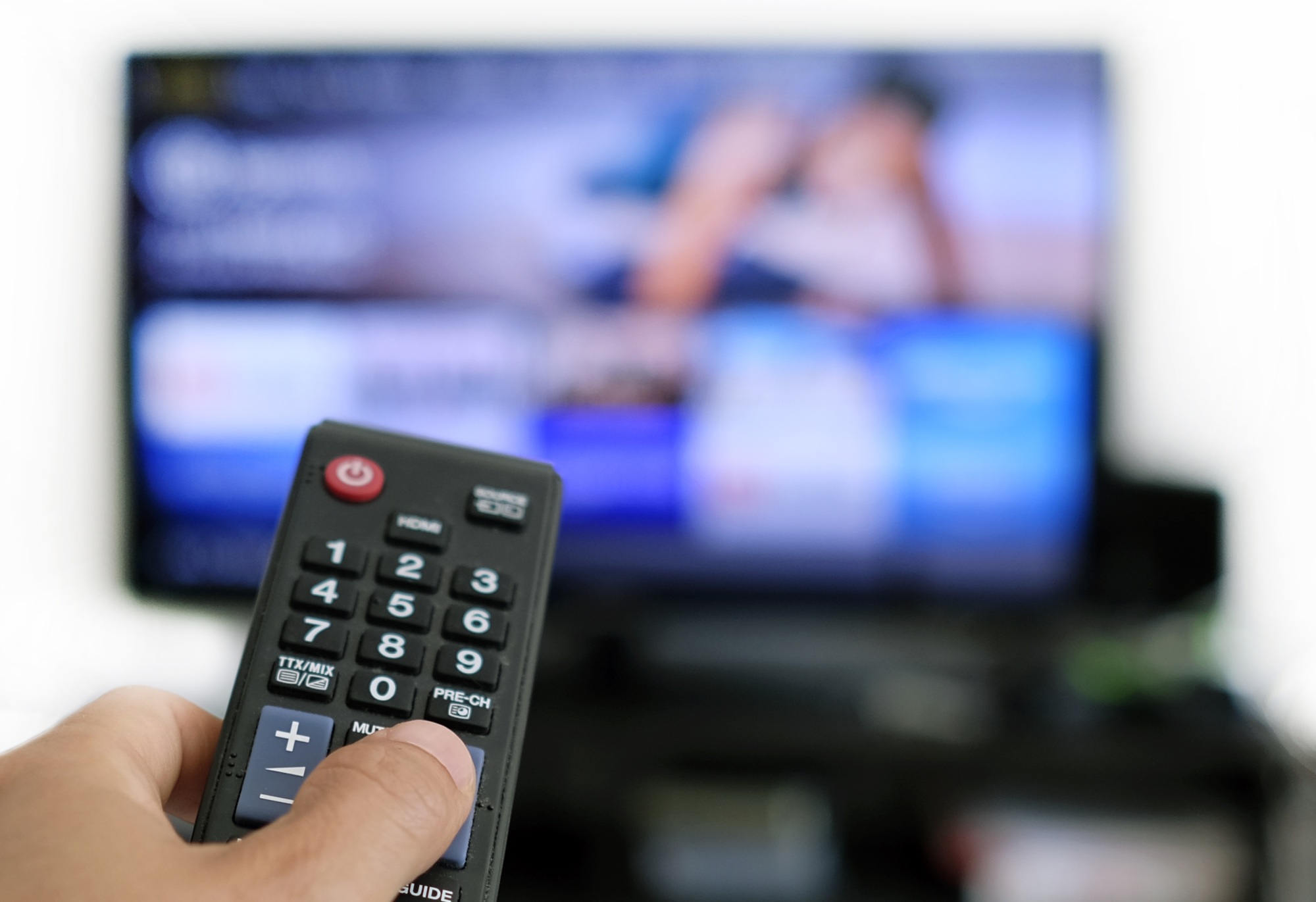 Remote control and screen - binge watching the favourite TV show