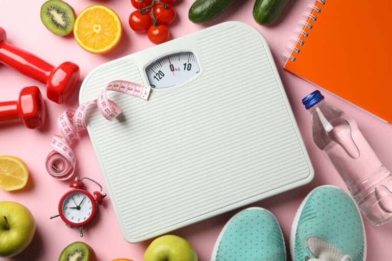 Weight loss or healthy lifestyle accessories on pink background
