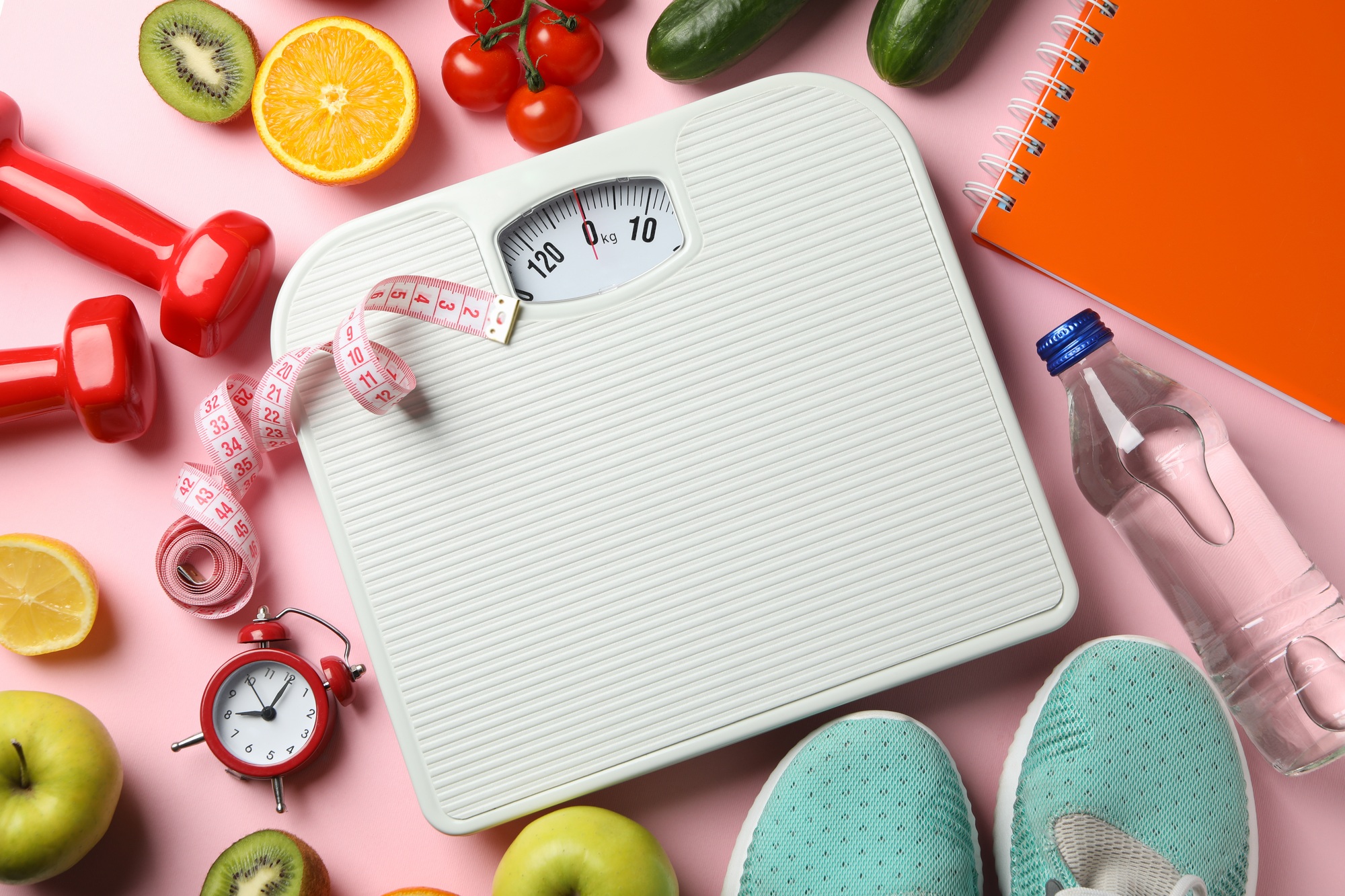 Weight loss or healthy lifestyle accessories on pink background