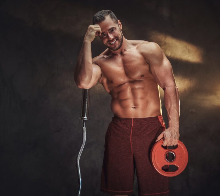 Young shirtless bodybuilder has a photo session